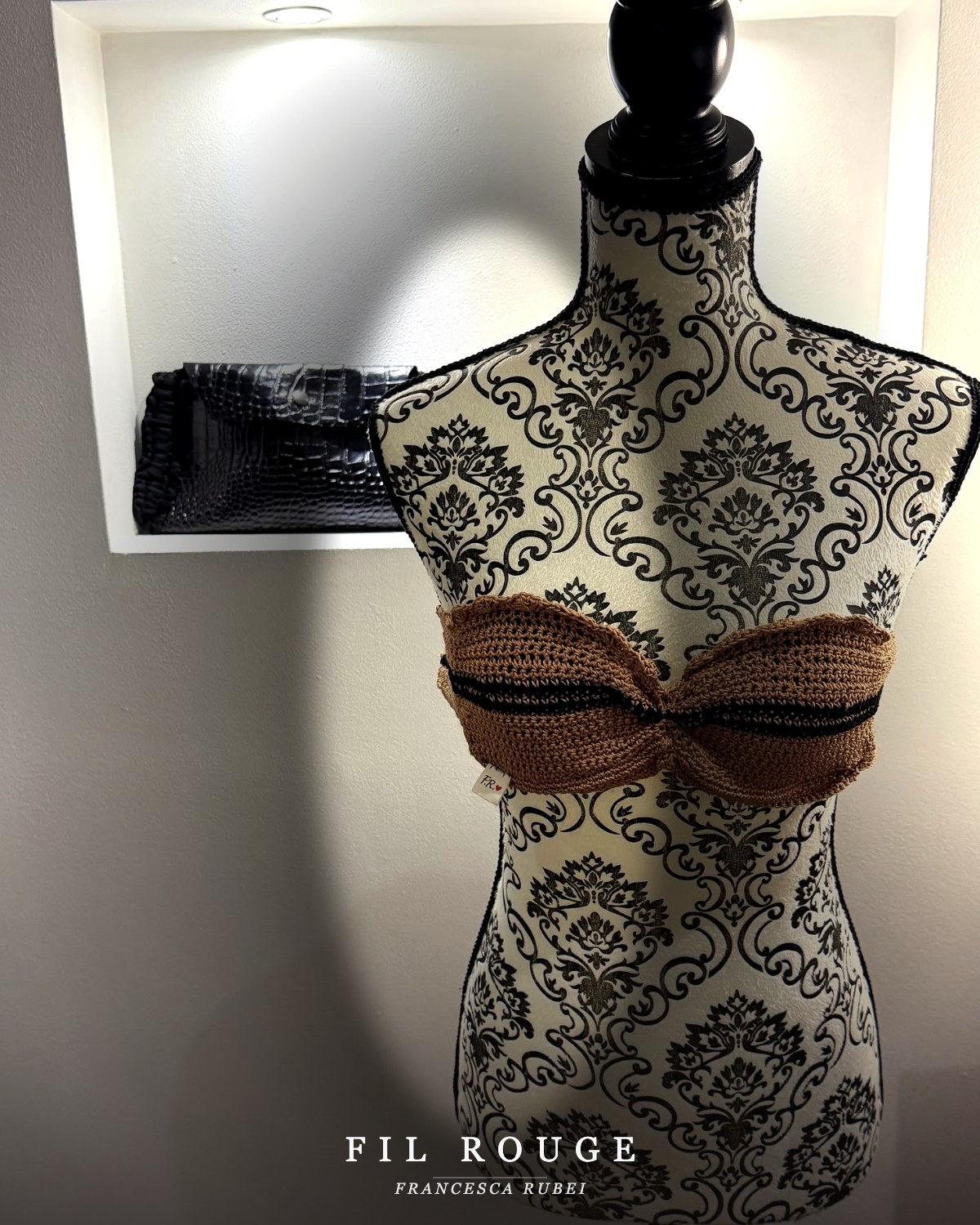Caramel and black striped crochet bandeau top on a damask mannequin