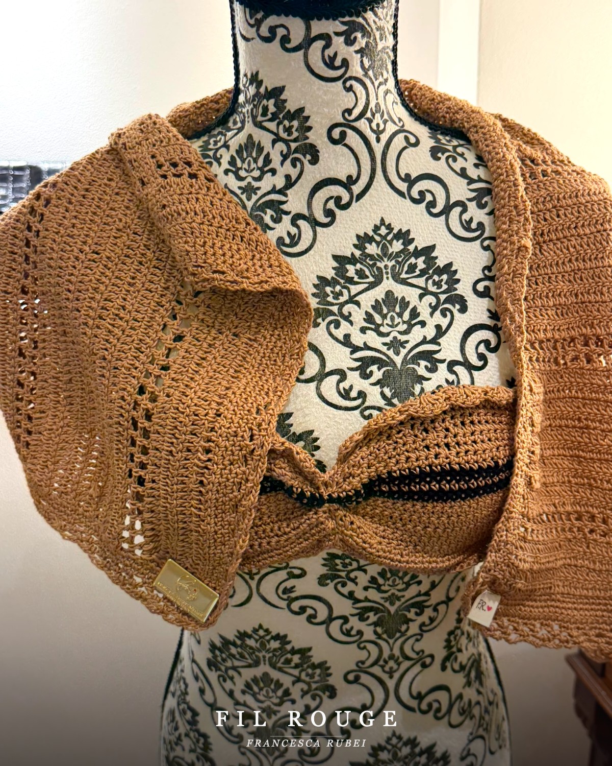 Caramel crochet bolero draped over a bandeau top